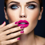 closeup portrat of sensual glamour beautiful woman model lady with fresh daily makeup and clean healthy skin face touching her pink lips